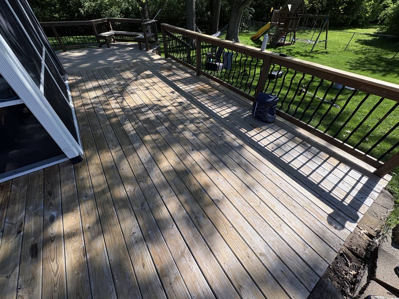 Wide view of the grey weathered deck before work began