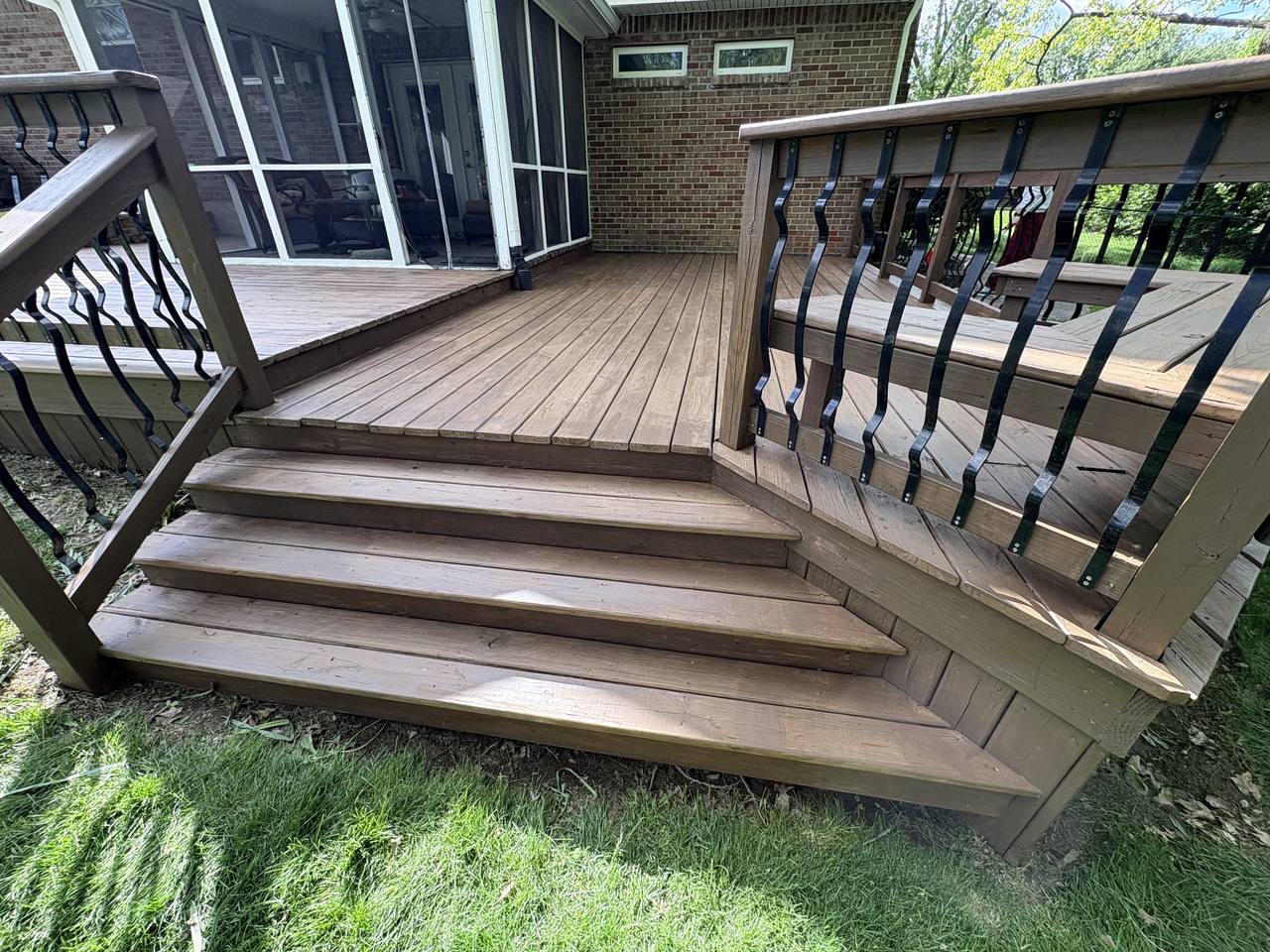 Deck steps and railings after washing, clean bare wood drying before stain